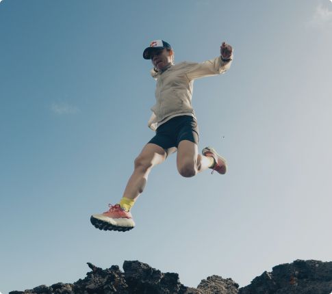 Person tying Merrell running shoes